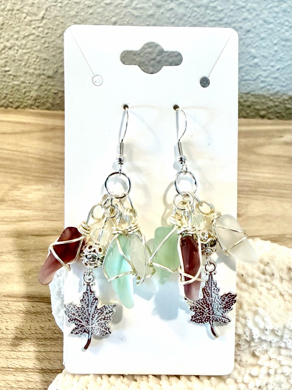 60. Handmade earrings with sea glass pieces and maple leaf charms
